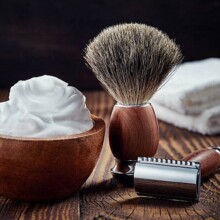 Shaving accessories on wooden background